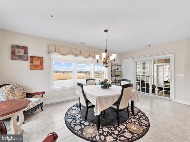 dining space featuring light tile patterned flooring and a chandelier