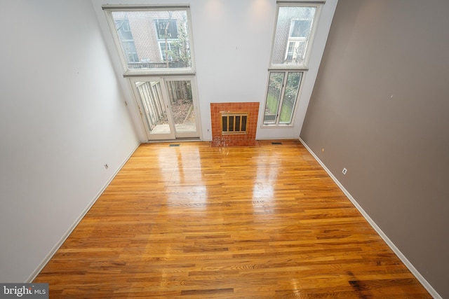 unfurnished living room featuring a fireplace and light hardwood / wood-style flooring