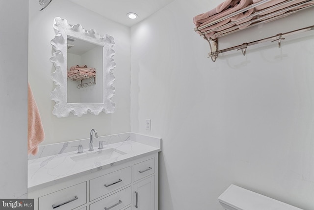 bathroom with vanity and toilet