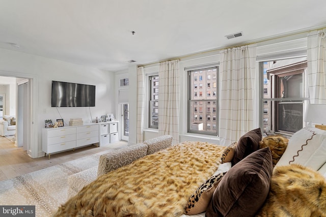 bedroom featuring visible vents and light wood-style flooring