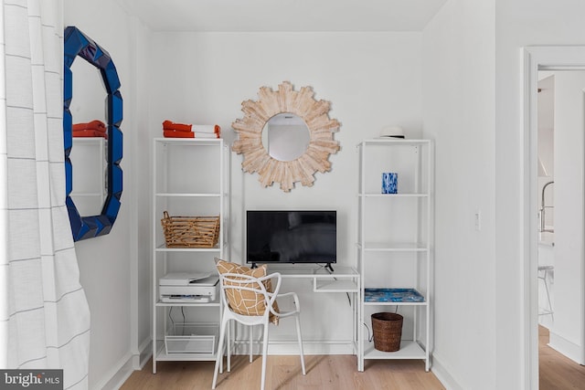 bedroom with baseboards and wood finished floors