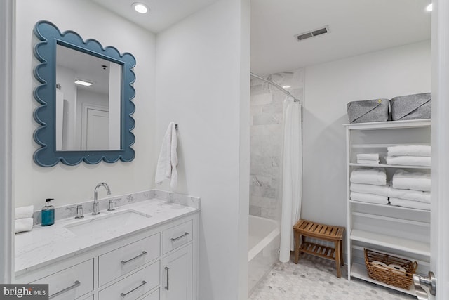 bathroom with shower / tub combo, visible vents, and vanity