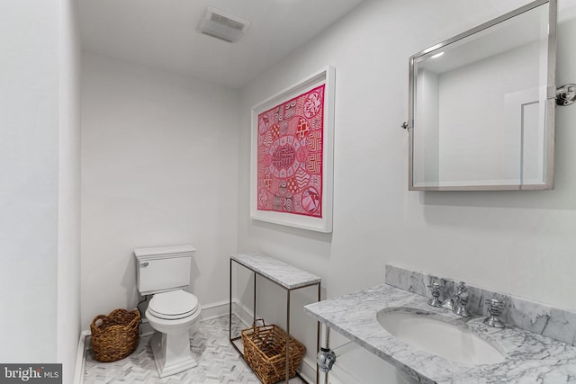 bathroom featuring baseboards, visible vents, a sink, and toilet