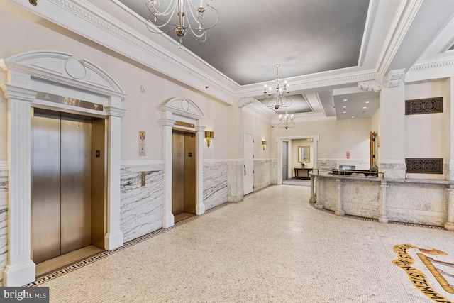 interior space featuring a chandelier, ornamental molding, wainscoting, and elevator