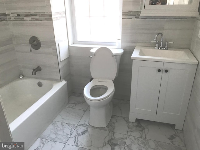 full bathroom with vanity, shower / bathing tub combination, tile walls, and toilet