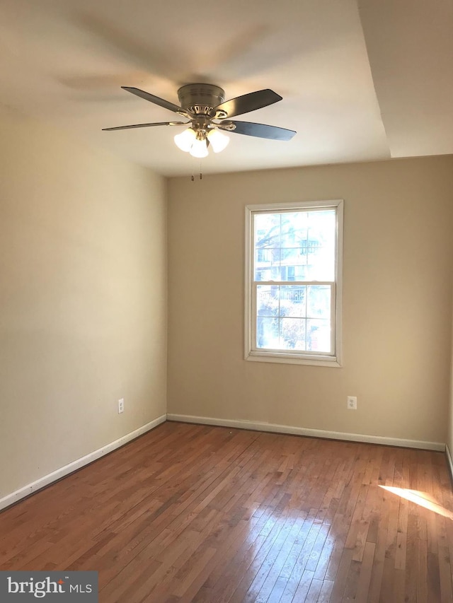 empty room featuring wood-type flooring and ceiling fan