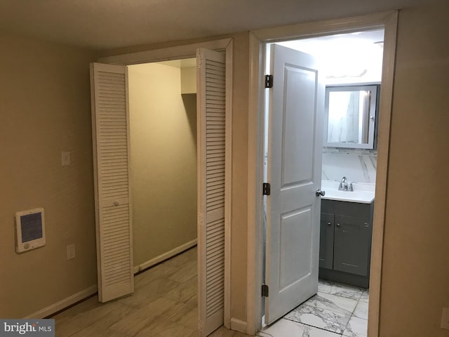 interior space featuring sink and heating unit