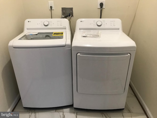 clothes washing area featuring washing machine and clothes dryer