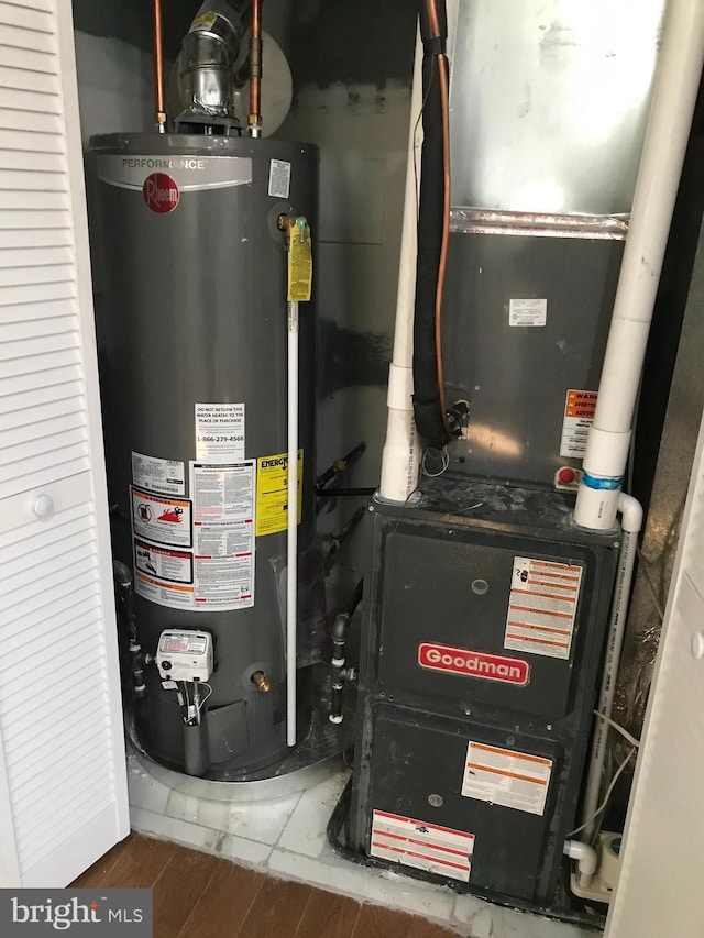 utility room with water heater and heating unit