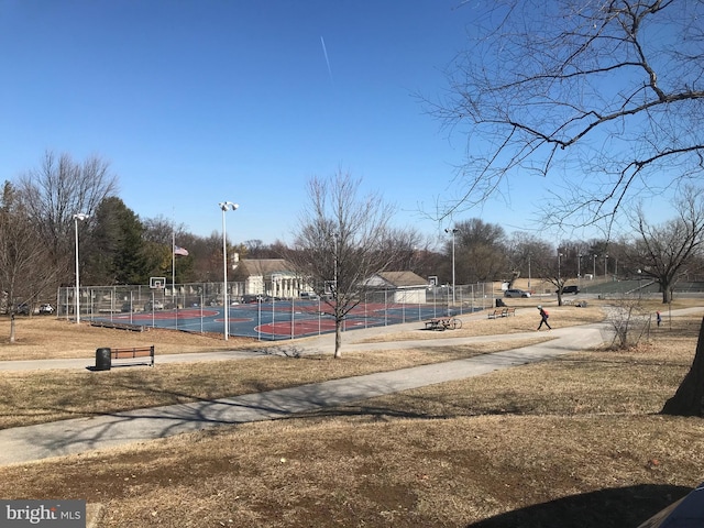 view of property's community featuring basketball hoop and tennis court