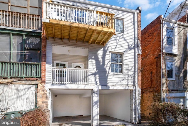 back of property with a balcony