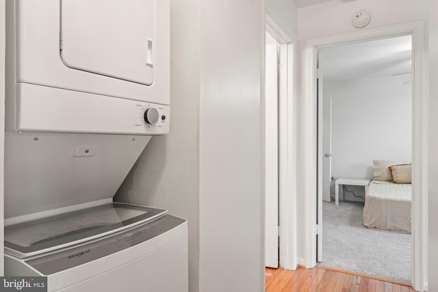 6913 Victoria, Alexandria, VA 22310 - laundry room with light wood finished floors, stacked washer / dryer, and laundry area