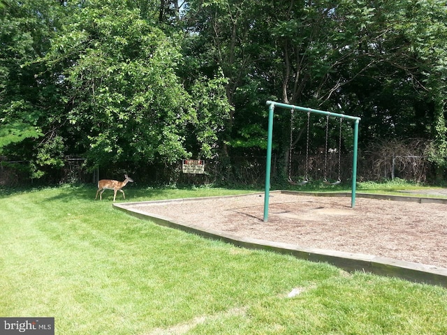 community jungle gym featuring a lawn