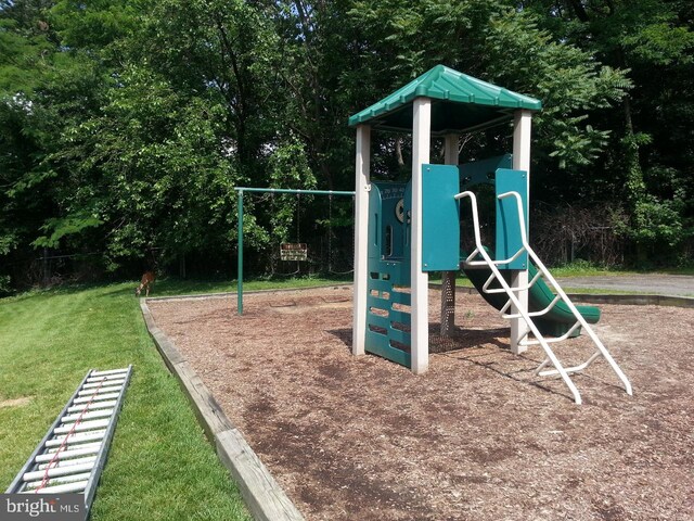 communal playground featuring a lawn