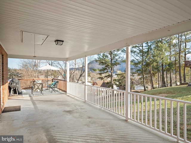 wooden terrace featuring a grill