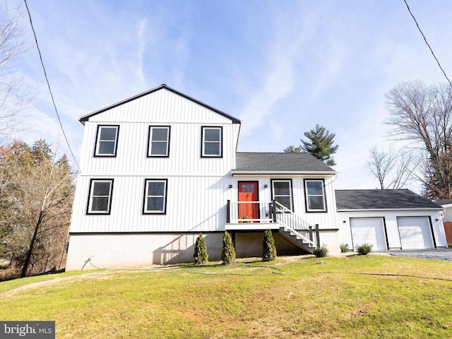 view of front of house with a garage and a front lawn