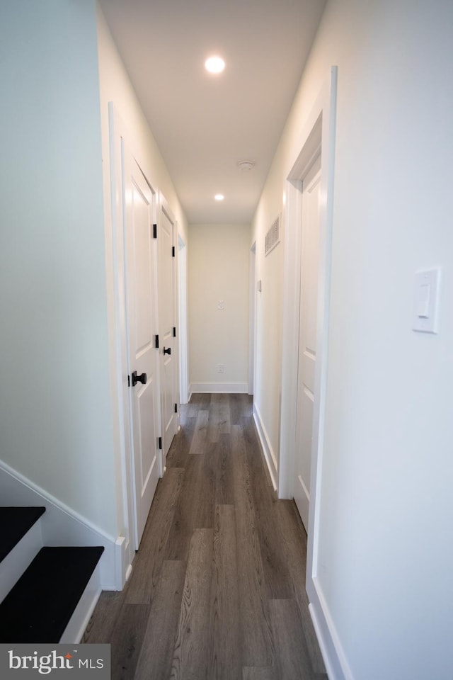 hallway with dark hardwood / wood-style floors