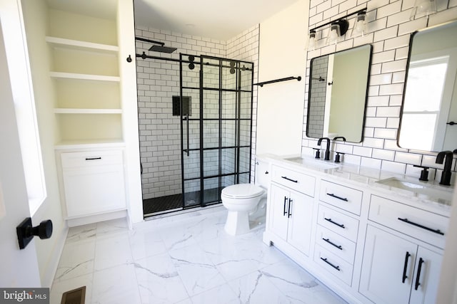 bathroom featuring vanity, toilet, and a shower with shower door