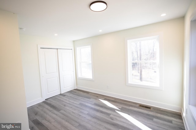 unfurnished bedroom with hardwood / wood-style floors and a closet