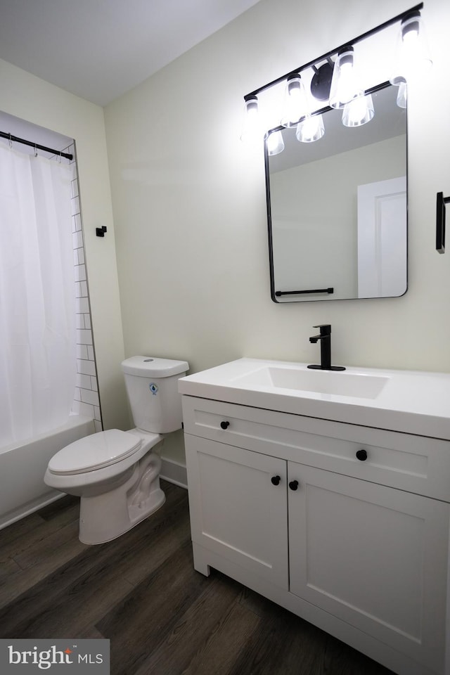 full bathroom featuring hardwood / wood-style flooring, vanity, shower / tub combo, and toilet