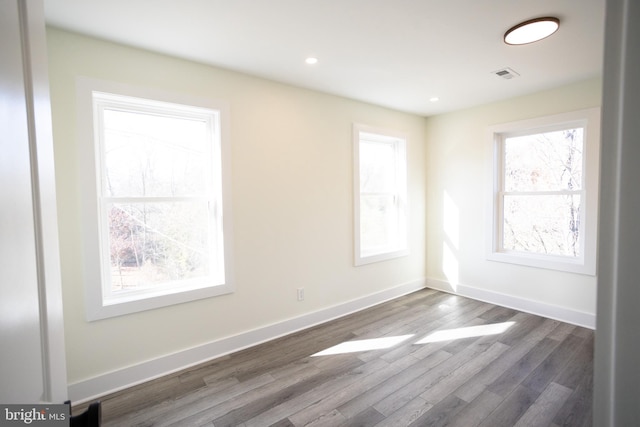 unfurnished room with dark hardwood / wood-style floors