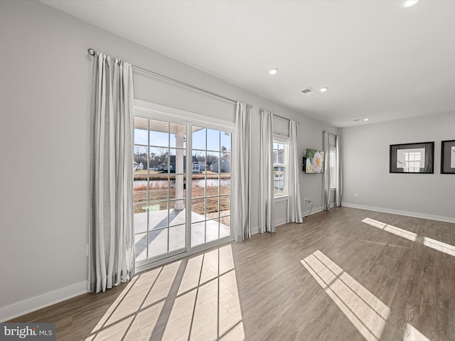 unfurnished room featuring hardwood / wood-style floors