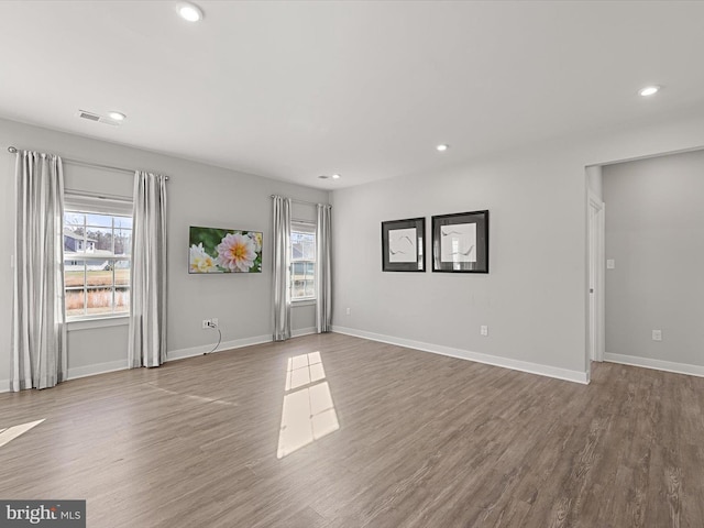 spare room with hardwood / wood-style flooring