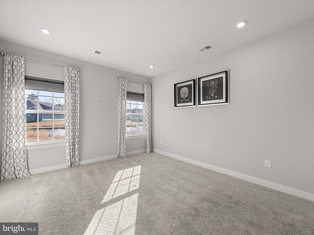 unfurnished room featuring light colored carpet