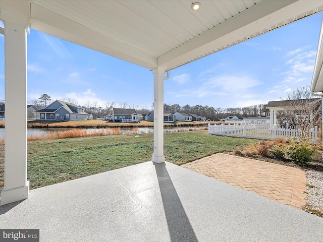 view of patio / terrace featuring a pergola and a water view