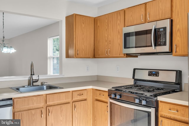 kitchen featuring pendant lighting, sink, and stainless steel appliances