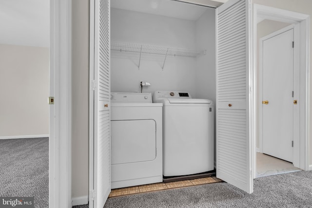 washroom with separate washer and dryer and light carpet