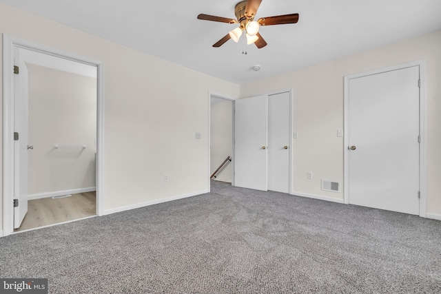 unfurnished bedroom featuring ceiling fan and light colored carpet