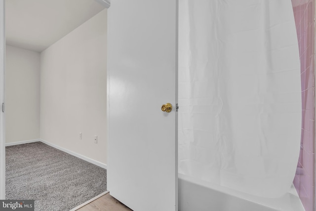 bathroom featuring shower / bathtub combination with curtain