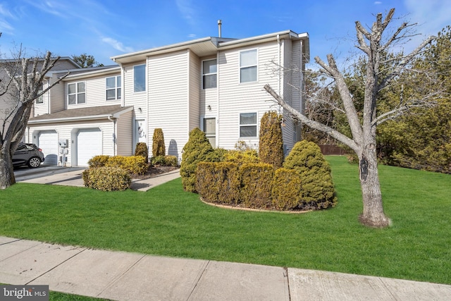 view of front of property featuring a garage and a front lawn