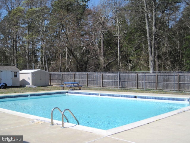 view of pool featuring a shed