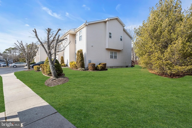 view of home's exterior with a yard