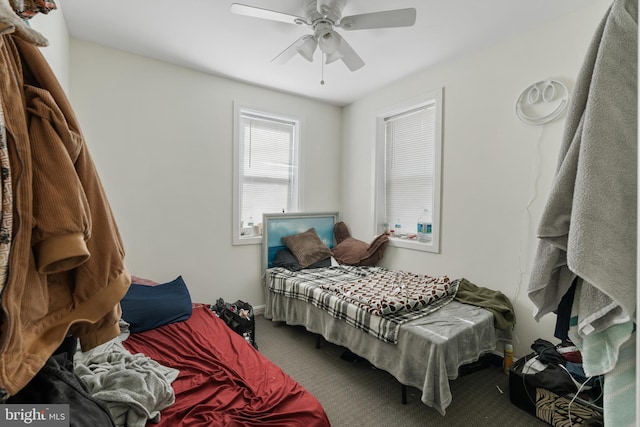 bedroom featuring ceiling fan and carpet