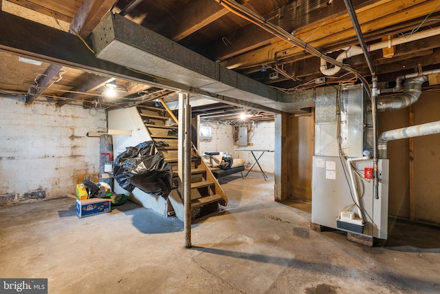 basement featuring heating unit and electric panel