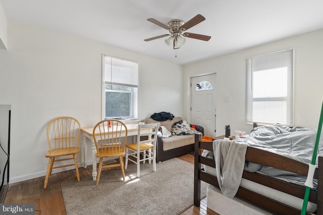 bedroom with hardwood / wood-style flooring and multiple windows