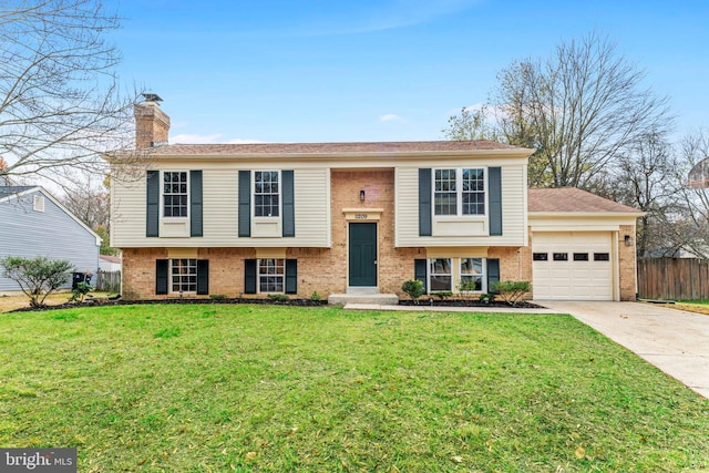 bi-level home with a garage and a front yard