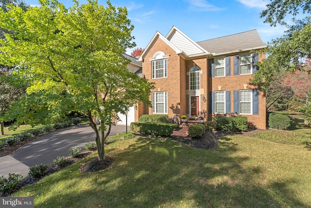 view of front of property featuring a garage and a front yard