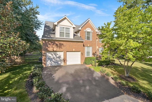 view of front of house with a garage and a front yard