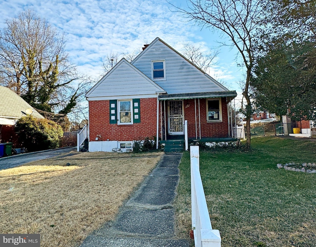 bungalow-style house with a front lawn