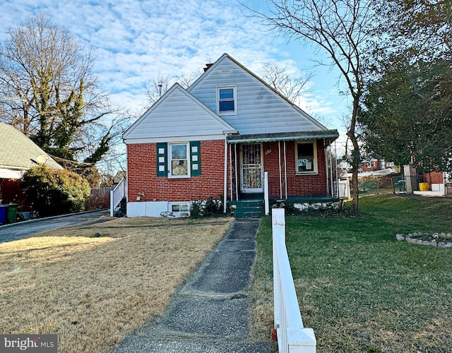 bungalow-style house with a front lawn