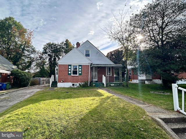 bungalow-style home featuring a front lawn