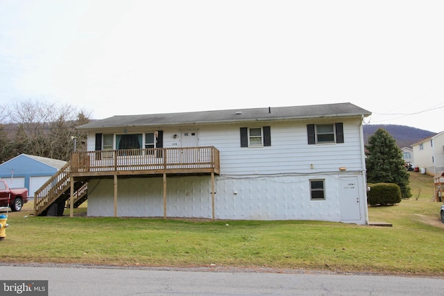 back of house featuring a yard and a deck