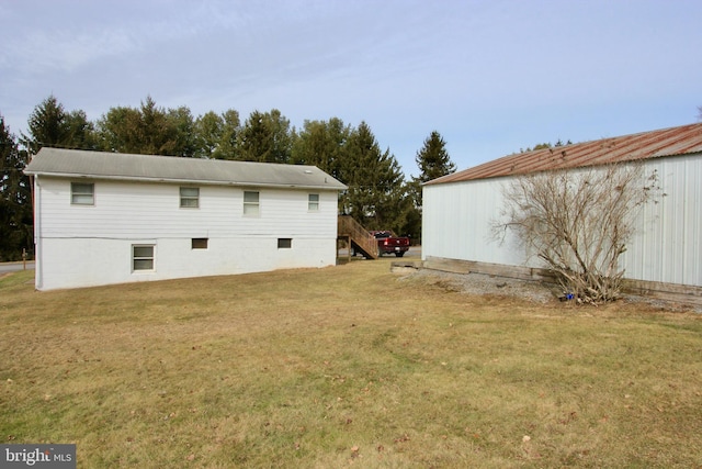 back of property featuring a yard