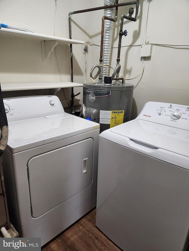 washroom with washer and dryer, electric water heater, and dark hardwood / wood-style flooring