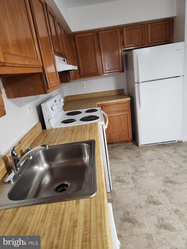 kitchen with white appliances and sink