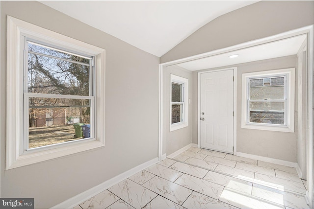 entryway featuring lofted ceiling and plenty of natural light